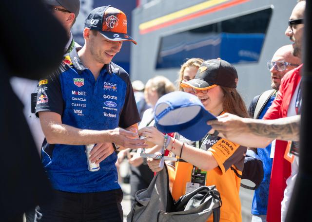 Red Bull Racing's Dutch driver Max Verstappen signs autographs as he arrives to the paddock prior to the first practice session at the Red Bull Ring race track in Spielberg, Austria on June 26, 2026, ahead of the Formula One Austrian Grand Prix. (Photo by Joe KLAMAR / AFP)