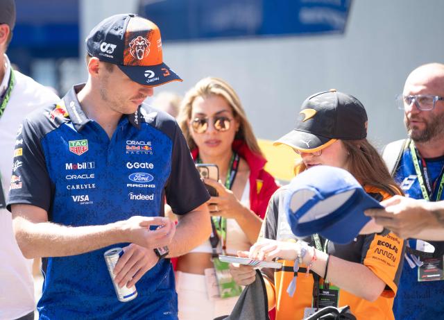 Red Bull Racing's Dutch driver Max Verstappen signs autographs as he arrives to the paddock prior to the first practice session at the Red Bull Ring race track in Spielberg, Austria on June 26, 2026, ahead of the Formula One Austrian Grand Prix. (Photo by Joe KLAMAR / AFP)