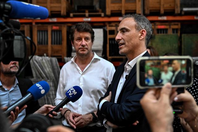 Place publique's centre-left party leader and MEP Raphael Glucksmann (R) and green party Les Ecologists senator Yannick Jadot (C) speak to reporters during a visit to the Envie 2E Aquitaine professional insertion company, in Artigues-pres-Bordeaux, outside Bordeaux, southwestern France on June 26, 2026. (Photo by Christophe ARCHAMBAULT / AFP)