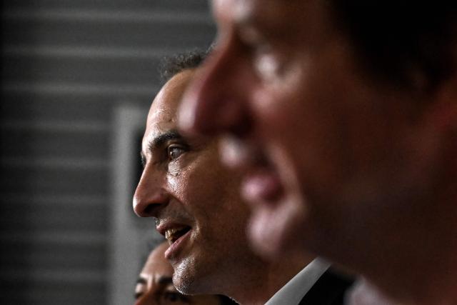 Place publique's centre-left party leader and MEP Raphael Glucksmann (C) and green party Les Ecologists senator Yannick Jadot (R) speak to reporters during a visit to the Envie 2E Aquitaine professional insertion company, in Artigues-pres-Bordeaux, outside Bordeaux, southwestern France on June 26, 2026. (Photo by Christophe ARCHAMBAULT / AFP)