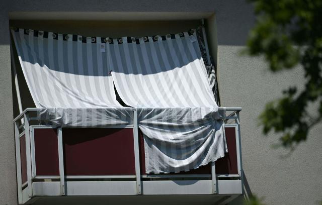 The balcony of an appartment is covered with curtains to reduce the heat inside, on June 26, 2026, in Vienna. Authorities banned alcohol and major weekend festivities as a deadly European heatwave was forecast to shift east on June 26, choking 150 million people under 35C temperatures. (Photo by HARALD SCHNEIDER / APA / AFP) / Austria OUT