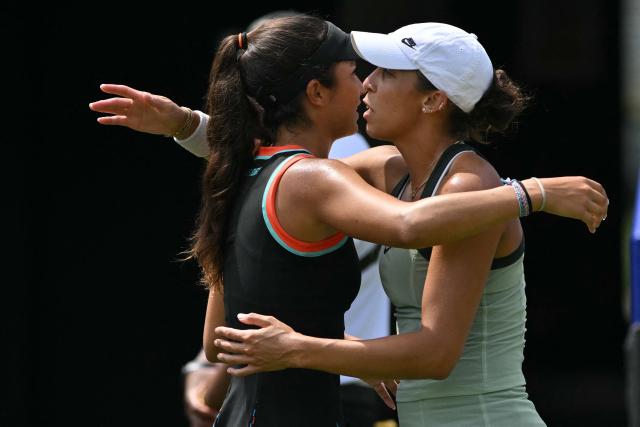 Croatia's Petra Marcinko (L) embraces US player Madison Keys (R) after she has to pull out of theri women's semi-final tennis match on day five of the Lexus Eastbourne Open at Devonshire Park, Eastbourne, on the south coast of England on June 26, 2026. (Photo by Glyn KIRK / AFP)