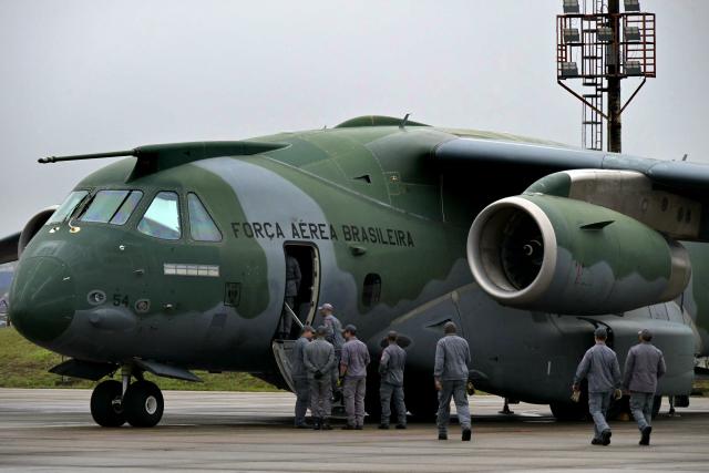 Brazilian firefighters, military personnel, and telecommunications technicians board a Brazilian Air Force plane for a humanitarian aid mission to Venezuela following deadly earthquakes, at Guarulhos air base in Guarulhos, Sao Paulo state, Brazil, on July 26 2026. Desperate Venezuelans raced to find and rescue loved ones trapped alive beneath the rubble of collapsed buildings after two major earthquakes, measured at magnitudes 7.2 and 7.5, hit northern Venezuela killing at least 235 people and leaving more than 1,500 injured. (Photo by NELSON ALMEIDA / AFP)