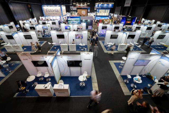 Visitors walk between the business fair stands during the second day of the Ukraine Recovery Conference (URC 2026) hosted by the Poland's Prime Minister in Gdansk, Poland, on June 26, 2026. The Ukraine Recovery Conference (URC 2026), co-hosted by Poland and Ukraine, takes place in Gdansk on June 25–26, 2026, aiming to strengthen support for Ukraine’s reconstruction and boost investment, with a focus on energy, critical infrastructure, and logistics sectors. (Photo by Wojtek RADWANSKI / AFP)