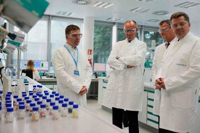 German Chancellor Friedrich Merz (2nd L) visits pharmaceutical company Salutas Pharma with Saxony-Anhalt's State Premier Sven Schulze (R) in Barleben, near Magdeburg, eastern Germany on June 26, 2026. (Photo by Matthias Schrader / POOL / AFP)
