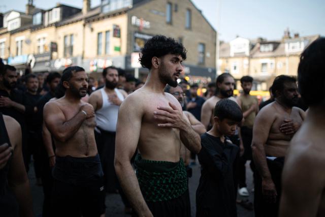 Shia Muslims take part in the annual Ashura procession in Bradford, northern England on June 26, 2026. Shiite Muslims, on the tenth day of the Islamic month of Muharram which marks the peak of Ashura, commemorate the martyrdom of Prophet Mohammad's grandson Imam Hussein, who was killed in the battle of Karbala in modern-day Iraq, in 680 AD. (Photo by Oli SCARFF / AFP)