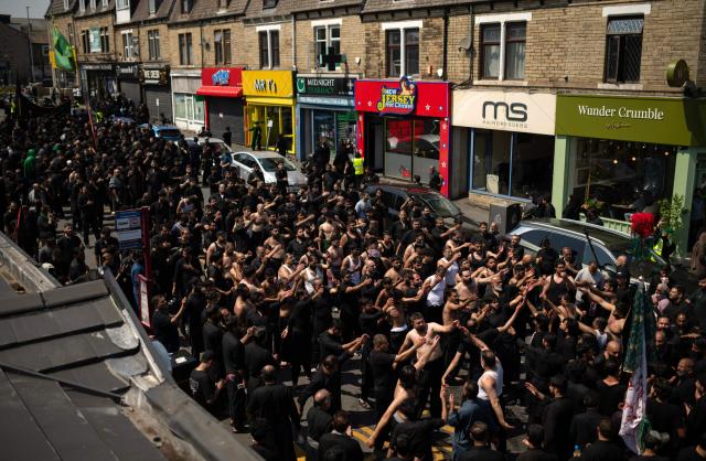 Shia Muslims take part in the annual Ashura procession in Bradford, northern England on June 26, 2026. Shiite Muslims, on the tenth day of the Islamic month of Muharram which marks the peak of Ashura, commemorate the martyrdom of Prophet Mohammad's grandson Imam Hussein, who was killed in the battle of Karbala in modern-day Iraq, in 680 AD. (Photo by Oli SCARFF / AFP)