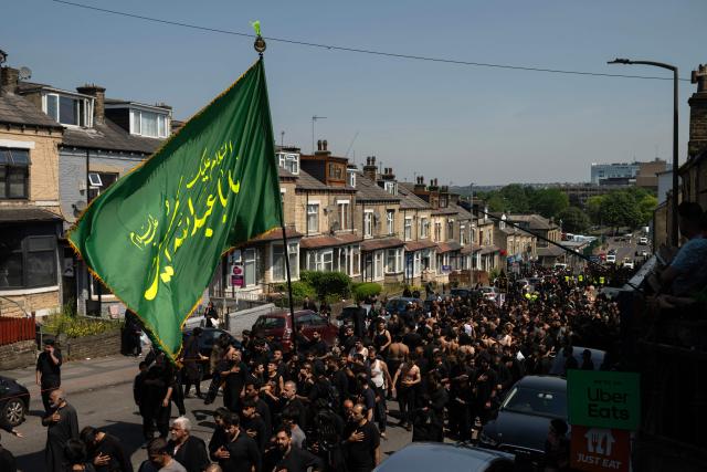 Shia Muslims take part in the annual Ashura procession in Bradford, northern England on June 26, 2026. Shiite Muslims, on the tenth day of the Islamic month of Muharram which marks the peak of Ashura, commemorate the martyrdom of Prophet Mohammad's grandson Imam Hussein, who was killed in the battle of Karbala in modern-day Iraq, in 680 AD. (Photo by Oli SCARFF / AFP)