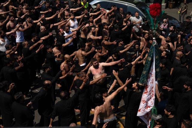 Shia Muslims take part in the annual Ashura procession in Bradford, northern England on June 26, 2026. Shiite Muslims, on the tenth day of the Islamic month of Muharram which marks the peak of Ashura, commemorate the martyrdom of Prophet Mohammad's grandson Imam Hussein, who was killed in the battle of Karbala in modern-day Iraq, in 680 AD. (Photo by Oli SCARFF / AFP)