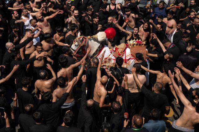 Shia Muslims take part in the annual Ashura procession in Bradford, northern England on June 26, 2026. Shiite Muslims, on the tenth day of the Islamic month of Muharram which marks the peak of Ashura, commemorate the martyrdom of Prophet Mohammad's grandson Imam Hussein, who was killed in the battle of Karbala in modern-day Iraq, in 680 AD. (Photo by Oli SCARFF / AFP)