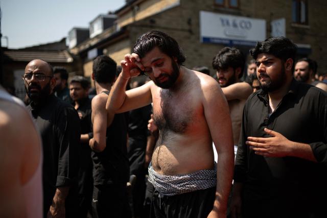 Shia Muslims take part in the annual Ashura procession in Bradford, northern England on June 26, 2026. Shiite Muslims, on the tenth day of the Islamic month of Muharram which marks the peak of Ashura, commemorate the martyrdom of Prophet Mohammad's grandson Imam Hussein, who was killed in the battle of Karbala in modern-day Iraq, in 680 AD. (Photo by Oli SCARFF / AFP)