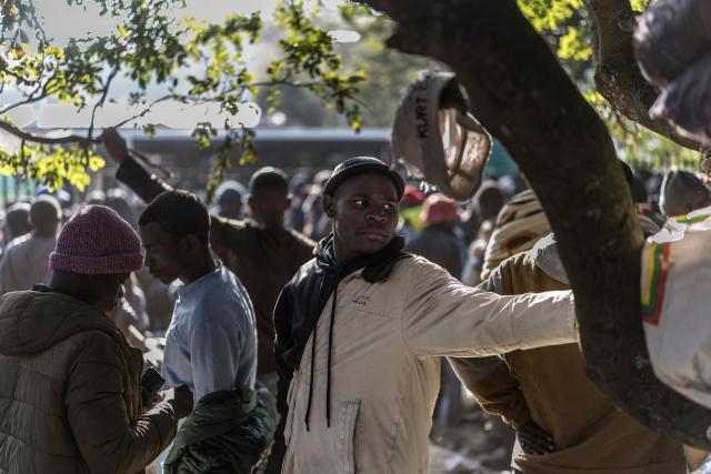 Malawian undocumented migrants gather as they line up hoping to board buses taking them back home at a temporary site along Mayor's Walk in Pietermaritzburg, on June 26, 2026. South Africans President Cyril Ramaphosa vowed on Thursday to crush any attempts to destabilise the nation during planned anti-immigrant marches next week, amid a wave of xenophobia.Citizen-led groups have set Tuesday 30 as a deadline for undocumented foreigners to leave and called for nationwide marches against illegal immigration, marking a crescendo in months of protests that have at times turned violent. (Photo by MARCO LONGARI / AFP)