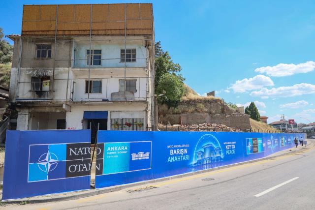 This photograph shows billboards with the slogans “Key to Peace,” “Key to Security,” and “Shared Future in Peace”, displayed along the boulevard on the protocol route ahead of the NATO Summit in Ankara, on 26 June 2026. The 36th NATO summit will be held in Ankara on July 7-8, 2026. (Photo by ADEM ALTAN / AFP)