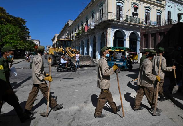 Cuban soldiers head to clear rubbish from street-corner dumps caused by the breakdown of waste collection amid the country’s ongoing crisis, in Old Havana, Cuba, on June 26, 2026. (Photo by YAMIL LAGE / AFP)