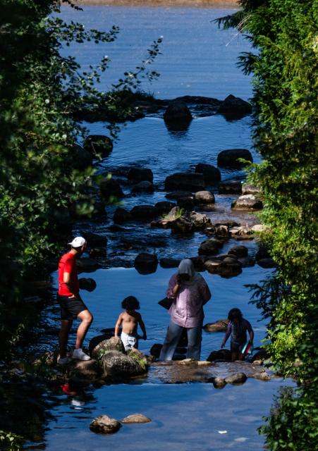 A family cools off in a cascade at Berlin's Viktoria Park on June 26, 2026, as temperatures went past 30 degrees Centigrade in the German capital. Germany saw temperatures break 40C at several locations in the country on June 26, 2026, according to preliminary weather service data, breaking the previous recorded high of 39.6C for the month of June. (Photo by John MACDOUGALL / AFP)