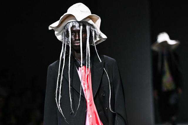A model presents a creation for Comme des Garcons for the Menswear Spring/Summer 2027 collection fashion show as part of the Paris Fashion Week, in Paris on June 26, 2026. (Photo by JULIEN DE ROSA / AFP)