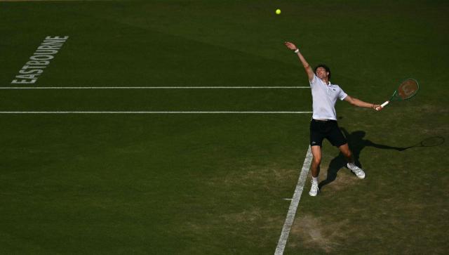 France's Ugo Humbert serves against Britain's Jack Draper during their men's semi-final tennis match on day five of the Lexus Eastbourne Open at Devonshire Park, Eastbourne, on the south coast of England on June 26, 2026. (Photo by Glyn KIRK / AFP)