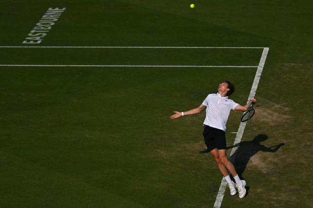 France's Ugo Humbert serves against Britain's Jack Draper during their men's semi-final tennis match on day five of the Lexus Eastbourne Open at Devonshire Park, Eastbourne, on the south coast of England on June 26, 2026. (Photo by Glyn KIRK / AFP)