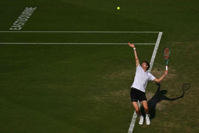 France's Ugo Humbert serves against Britain's Jack Draper during their men's semi-final tennis match on day five of the Lexus Eastbourne Open at Devonshire Park, Eastbourne, on the south coast of England on June 26, 2026. (Photo by Glyn KIRK / AFP)