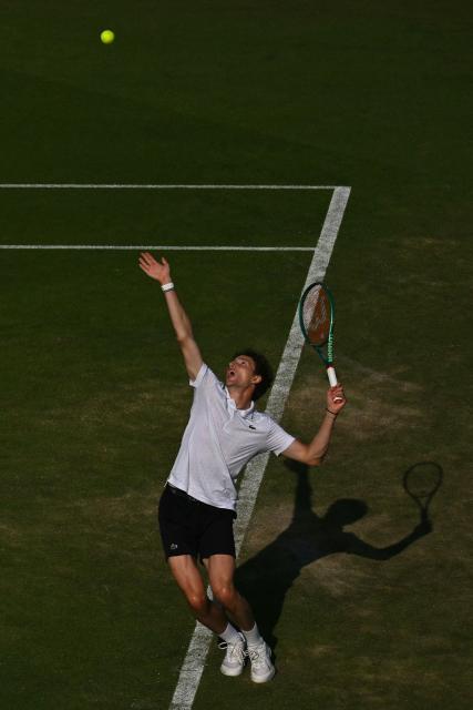 France's Ugo Humbert serves against Britain's Jack Draper during their men's semi-final tennis match on day five of the Lexus Eastbourne Open at Devonshire Park, Eastbourne, on the south coast of England on June 26, 2026. (Photo by Glyn KIRK / AFP)