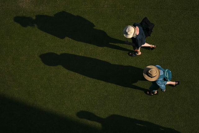 Spectators cast shadows during the Lexus Eastbourne Open at Devonshire Park, Eastbourne, on the south coast of England on June 26, 2026. (Photo by Glyn KIRK / AFP)