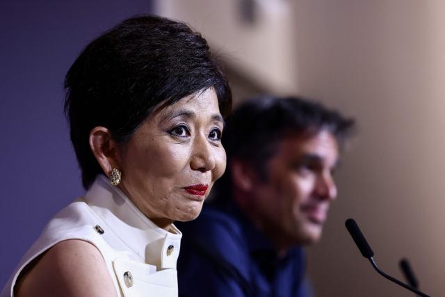 US businesswoman and President of Olympique Lyonnais Michele Kang (L) and Lyon’s German general manager Michael Gerlinger look on during a press conference at the Groupama Stadium in Decines-Charpieu near Lyon, central-eastern France, on June 26, 2026. The US businesswoman Michele Kang has become the majority shareholder of Olympique Lyonnais (Ligue 1), which she has been managing for the past year, according to Eagle Football Group, the club’s previous owner. (Photo by Alex MARTIN / AFP)
