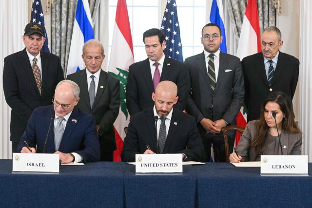 US Secretary of State Marco Rubio (C, back) looks on as (L/R, front row) Israeli Ambassador to the US Yechiel Leiter, State Department Chief of Staff Daniel Holler, and Lebanese Ambassador to the US Nada Hamadeh sign a framework agreement at the US Department of State in Washington, DC, on June 26, 2026. Lebanon, Israel and the United States on Friday signed a trilateral framework agreement aimed at paving the way for a peace deal between the two long-time Middle East adversaries. (Photo by SAUL LOEB / AFP)