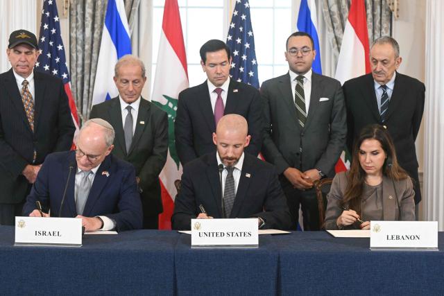 US Secretary of State Marco Rubio (C, back) looks on as (L/R, front row) Israeli Ambassador to the US Yechiel Leiter, State Department Chief of Staff Daniel Holler, and Lebanese Ambassador to the US Nada Hamadeh sign a framework agreement at the US Department of State in Washington, DC, on June 26, 2026. Lebanon, Israel and the United States on Friday signed a trilateral framework agreement aimed at paving the way for a peace deal between the two long-time Middle East adversaries. (Photo by SAUL LOEB / AFP)