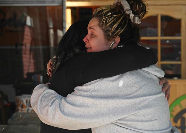 Two women hug at a collection centre where Venezuelans living in Santiago gather supplies to send to their earthquake-stricken homeland, on June 26, 2026, in Santiago, Chile. So far, 589 deaths and more than 50,000 missing people have been reported. after twin earthquakes in Venezuela, as international rescue teams and sniffer dogs arrived to join a desperate search for survivors. (Photo by RODRIGO ARANGUA / AFP)
