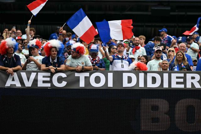 French fans display a banner that reads in French, "With you, Didier," ahead of the 2026 World Cup Group I football match between Norway and France at the Boston Stadium in Foxborough on June 26, 2026.  (Photo by Jewel SAMAD / AFP)