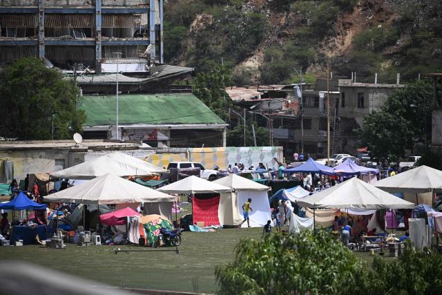 Residents take shelter at a sports field in Catia La Mar, La Guaira, Venezuela, on June 26, 2026, following earthquakes. The death toll from two powerful earthquakes that devastated Venezuela earlier this week rose to 920 on June 26, National Assembly President Jorge Rodriguez said. (Photo by Federico PARRA / AFP)