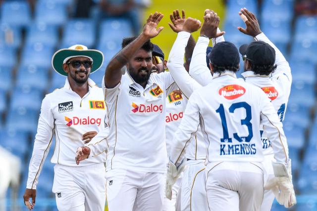 Asitha Fernando (2L) and Pasindu Sooriyabandara (L) of Sri Lanka celebrate the dismissal of Joshua Da Silva of West Indies during the second day of the first Test cricket match between West Indies and Sri Lanka at Sir Vivian Richards Stadium in North Sound, Antigua and Barbuda, on June 26, 2026. (Photo by Randy Brooks / AFP)