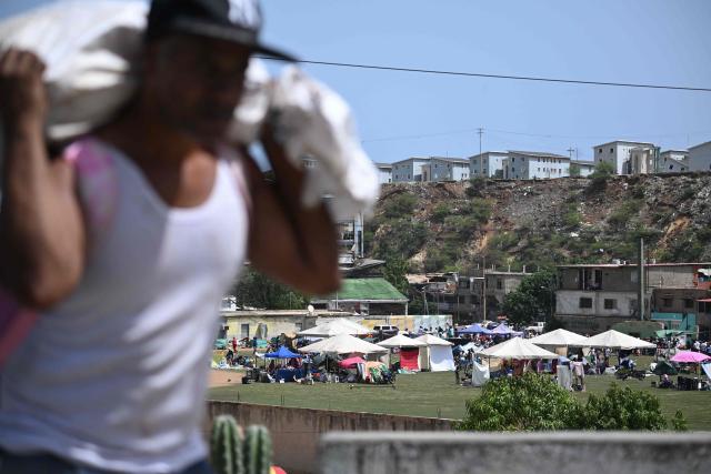 Residents take shelter at a sports field in Catia La Mar, La Guaira, Venezuela, on June 26, 2026, following earthquakes. The death toll from two powerful earthquakes that devastated Venezuela earlier this week rose to 920 on June 26, National Assembly President Jorge Rodriguez said. (Photo by Federico PARRA / AFP)