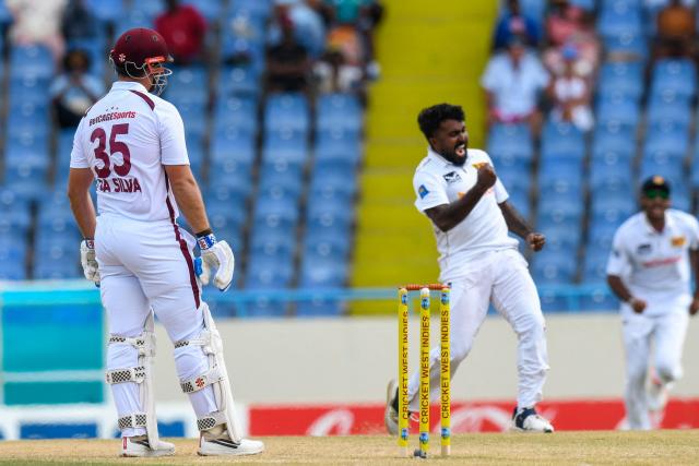 Joshua Da Silva (L) of West Indies is dismissed by Asitha Fernando (R) of Sri Lanka during the second day of the first Test cricket match between West Indies and Sri Lanka at Sir Vivian Richards Stadium in North Sound, Antigua and Barbuda, on June 26, 2026. (Photo by Randy Brooks / AFP)