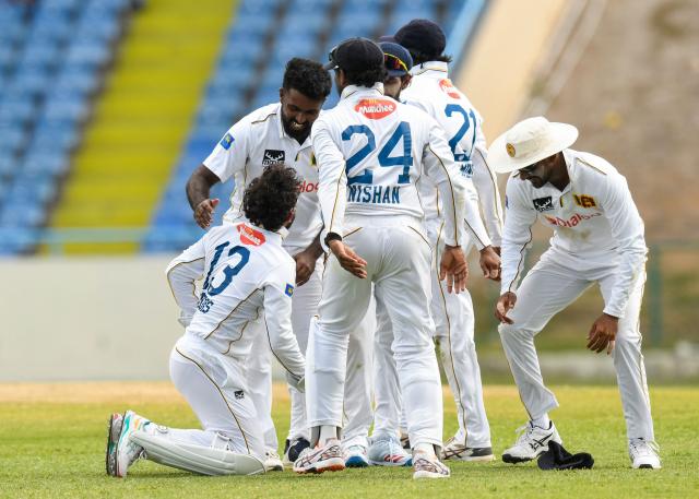 Asitha Fernando (L) of Sri Lanka celebrates the dismissal of Justin Greaves of West Indies during the second day of the first Test cricket match between West Indies and Sri Lanka at Sir Vivian Richards Stadium in North Sound, Antigua and Barbuda, on June 26, 2026. (Photo by Randy Brooks / AFP)