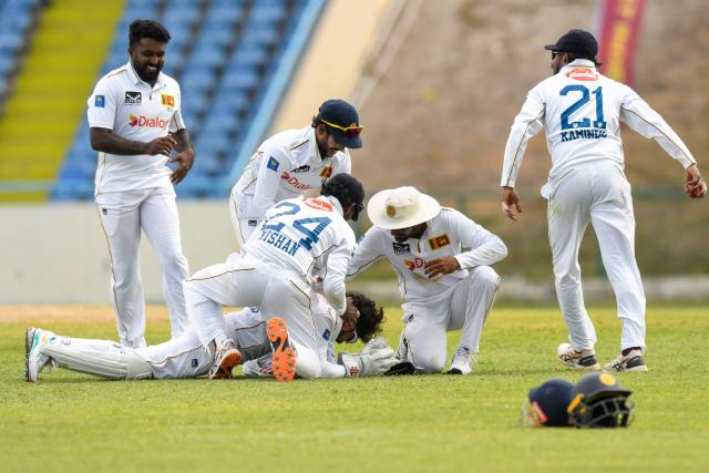 Asitha Fernando (L) of Sri Lanka celebrates the dismissal of Justin Greaves of West Indies during the second day of the first Test cricket match between West Indies and Sri Lanka at Sir Vivian Richards Stadium in North Sound, Antigua and Barbuda, on June 26, 2026. (Photo by Randy Brooks / AFP)