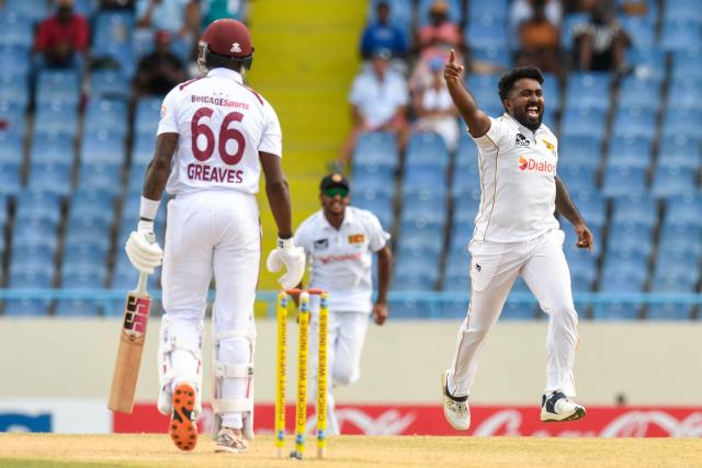 Asitha Fernando (R) of Sri Lanka celebrates the dismissal of Justin Greaves (L) of West Indies during the second day of the first Test cricket match between West Indies and Sri Lanka at Sir Vivian Richards Stadium in North Sound, Antigua and Barbuda, on June 26, 2026. (Photo by Randy Brooks / AFP)