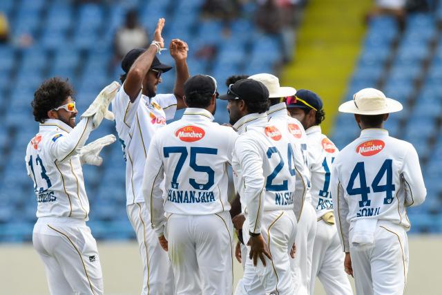 Kusal Mendis (L) of Sri Lanka celebrates the dismissal of Justin Greaves of West Indies during the second day of the first Test cricket match between West Indies and Sri Lanka at Sir Vivian Richards Stadium in North Sound, Antigua and Barbuda, on June 26, 2026. (Photo by Randy Brooks / AFP)