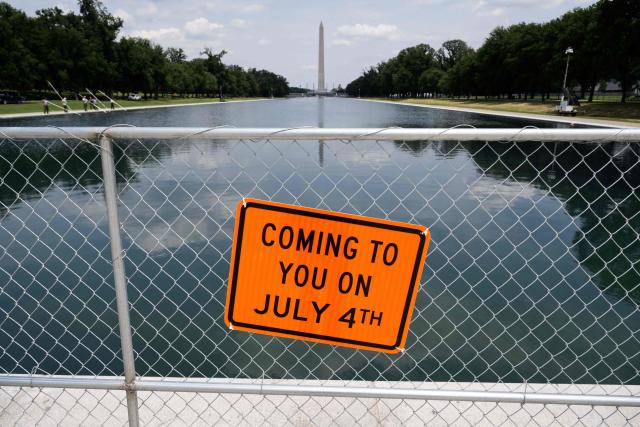 A sign is seen on a fence at the Reflecting Pool on the National Mall in Washington, DC, on June 26, 2026. US President Donald Trump on June 22 threatened jail time for anyone seeking to damage one of his signature renovation projects, the Reflecting Pool at the Lincoln Memorial in Washington, whose overhaul has become a political flashpoint. (Photo by SAUL LOEB / AFP)