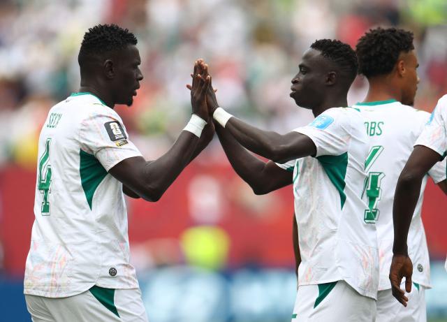 Senegal's defender #04 Abdoulaye Seck celebrates with teammate midfielder #05 Idrissa Gana Gueye after scoring his team's first goal during the 2026 World Cup Group I football match between Senegal and Iraq at the Toronto Stadium in Toronto on June 26, 2026.  (Photo by Cole Burston / AFP)