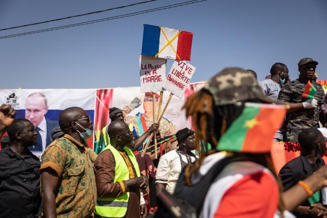 (FILES) A demonstrator holds placards during a protest to support the Burkina Faso President Captain Ibrahim Traore and to demand the departure of France's ambassador and military forces, in Ouagadougou, on January 20, 2023. The military junta in Burkina Faso said on Friday it was breaking off diplomatic ties with ex-colonial power France after years of tensions, accusing Paris of persistently acting against its interests. (Photo by OLYMPIA DE MAISMONT / AFP)