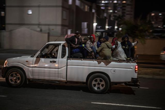 A group of undocumented migrants arrive at the gate of the old Durban Drive Inn where they will be registered by South African Immigration Officers ahead of their repatriation, in Durban on June 26, 2026. South Africa, one of Africa's largest and most industrialised economies, has been on edge following weeks of sometimes violent xenophobic unrest that has left at least two people dead. Small but organised groups have issued an ultimatum for undocumented migrants to exit or face consequences, a demand with no legal force. (Photo by MARCO LONGARI / AFP)