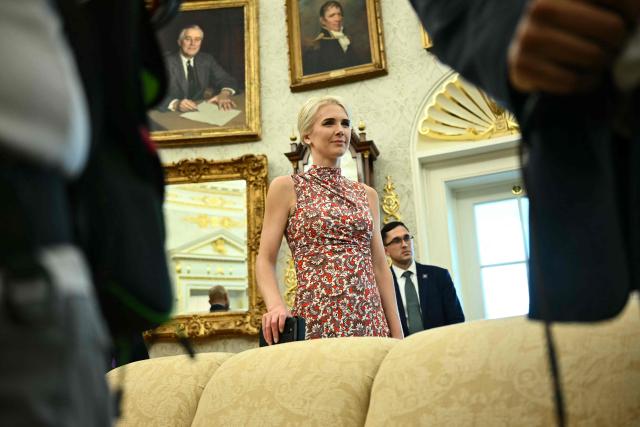 White House aide Natalie Harp is seen as US President Donald Trump presents findings of his Religious Liberty Commission in the Oval Office of the White House, in Washington, DC on June 26, 2026. (Photo by Kent NISHIMURA / AFP)