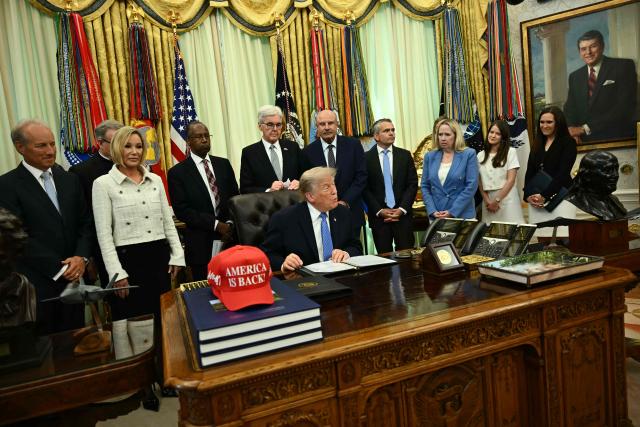 US President Donald Trump presents findings of his Religious Liberty Commission in the Oval Office of the White House, in Washington, DC on June 26, 2026. (Photo by Kent NISHIMURA / AFP)
