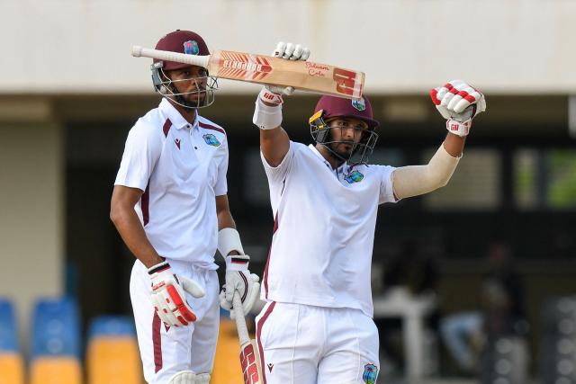 Amir Jangoo (R) of West Indies celebrates his half century and Roston Chase (L) looks on during the 2nd day of the 1st Test between Sri Lanka and West Indies at Vivian Richards Cricket Stadium in North Sound, Antigua and Barbuda, on June 26, 2026. (Photo by Randy Brooks / AFP)