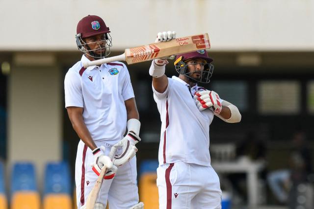 Amir Jangoo (R) of West Indies celebrates his half century and Roston Chase (L) looks on during the 2nd day of the 1st Test between Sri Lanka and West Indies at Vivian Richards Cricket Stadium in North Sound, Antigua and Barbuda, on June 26, 2026. (Photo by Randy Brooks / AFP)