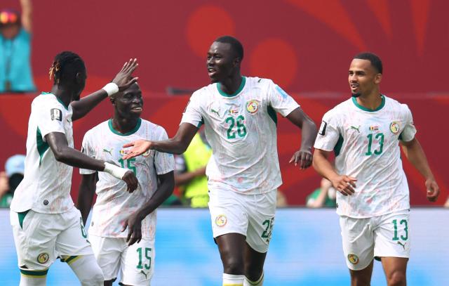 Senegal's midfielder #26 Pape Gueye celebrates with teammates after scoring his team's fouth goal during the 2026 World Cup Group I football match between Senegal and Iraq at the Toronto Stadium in Toronto on June 26, 2026.  (Photo by Cole Burston / AFP)