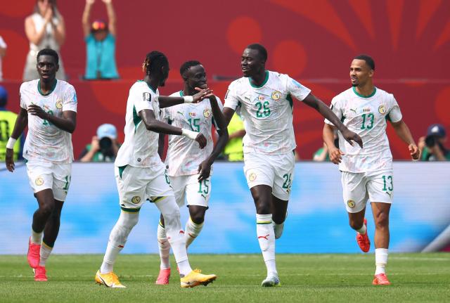 Senegal's midfielder #26 Pape Gueye celebrates with teammates after scoring his team's fouth goal during the 2026 World Cup Group I football match between Senegal and Iraq at the Toronto Stadium in Toronto on June 26, 2026.  (Photo by Cole Burston / AFP)