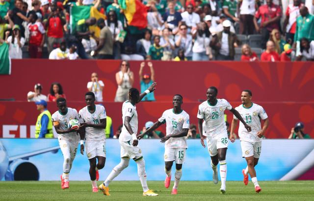 Senegal's midfielder #26 Pape Gueye celebrates with teammates after scoring his team's fouth goal during the 2026 World Cup Group I football match between Senegal and Iraq at the Toronto Stadium in Toronto on June 26, 2026.  (Photo by Cole Burston / AFP)