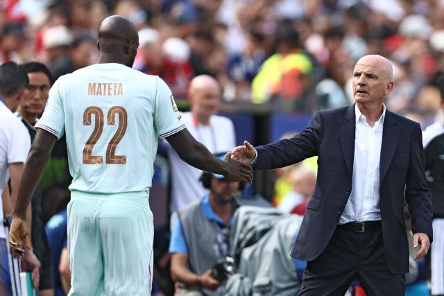 France's forward #22 Jean-Philippe Mateta greets France's assistant coach Guy Stephan during the 2026 World Cup Group I football match between Norway and France at the Boston Stadium in Foxborough on June 26, 2026.  (Photo by CHARLY TRIBALLEAU / AFP)